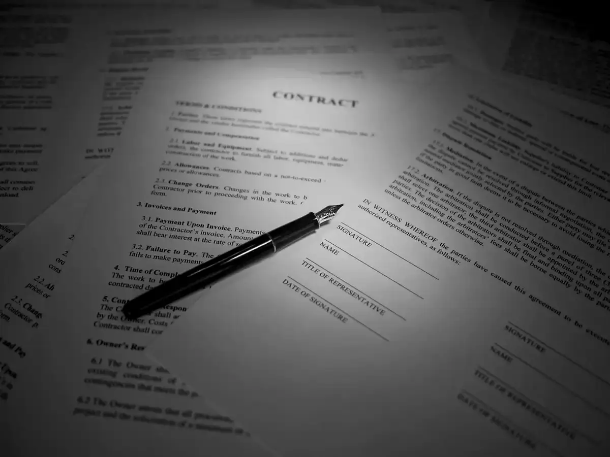 Pen lying on a printed legal agreement