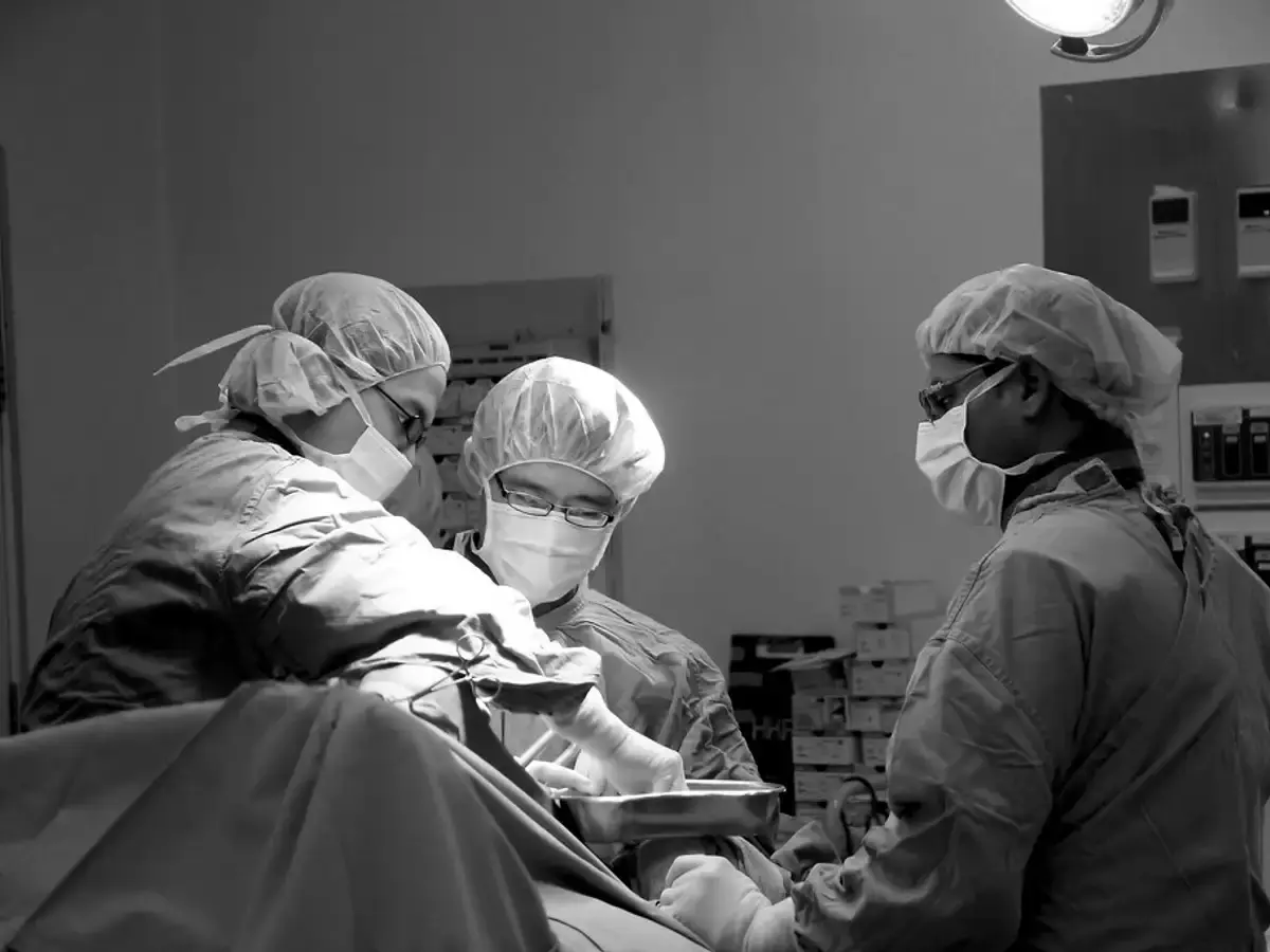 Surgical team in gowns and masks at work in an operating theatre
